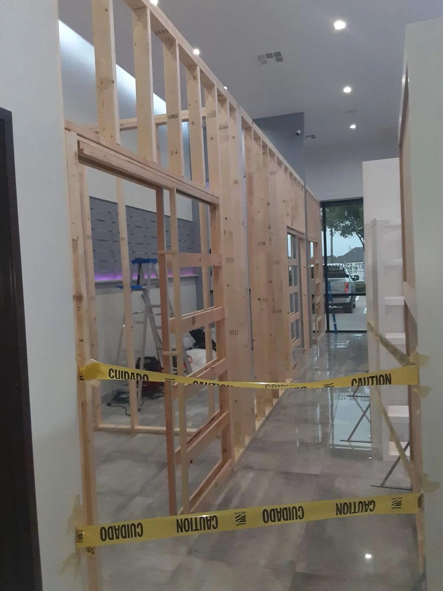 Wood-stud partition walls going up inside a commercial space during finish-out