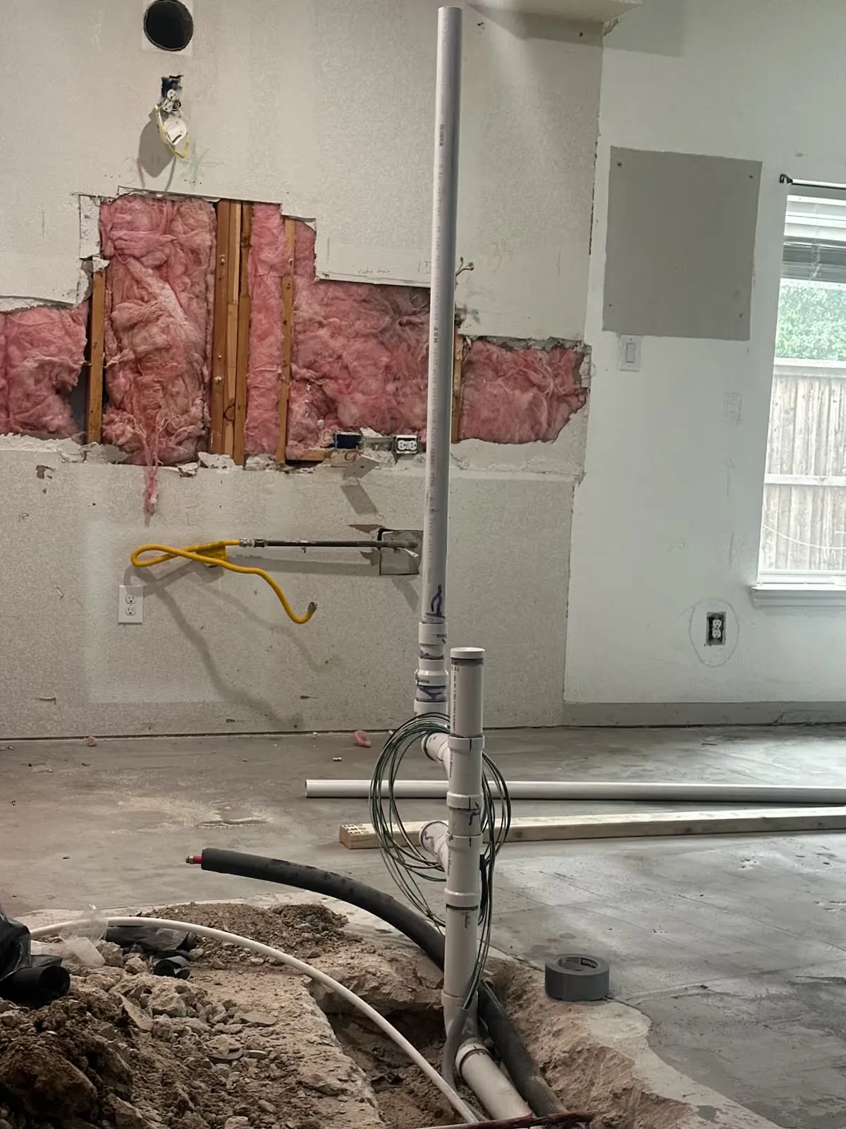 Opened wall and trenched slab for new plumbing lines during a renovation